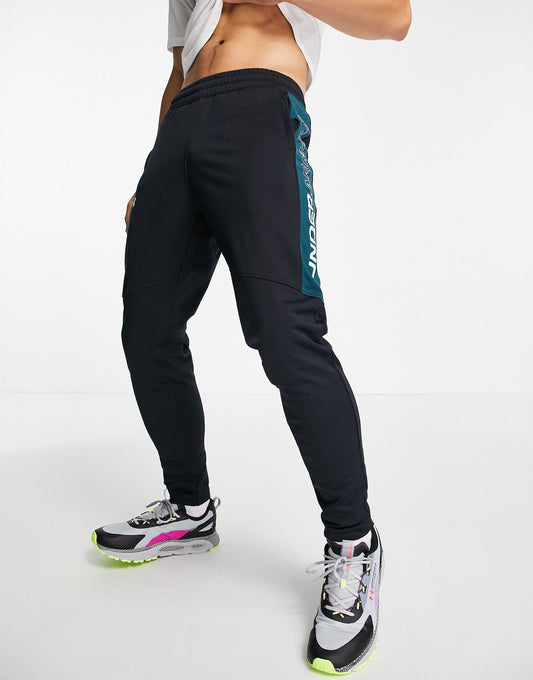 Under Armour Sportstyle graphic track pants in black and green