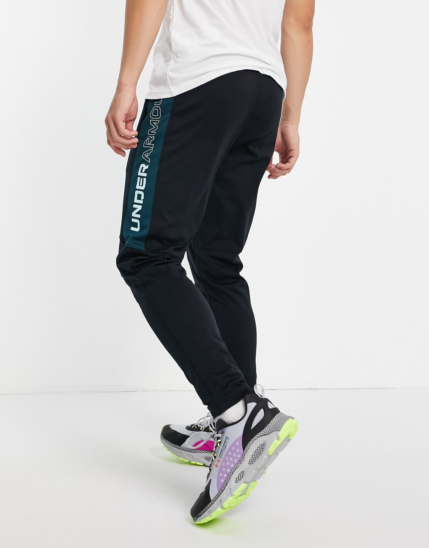 Under Armour Sportstyle graphic track pants in black and green