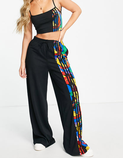 adidas Originals spliced floral wide leg trousers in black