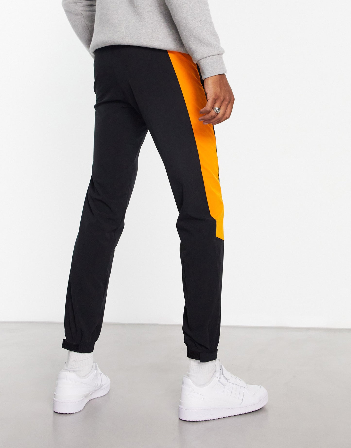 adidas Sportstyle Travel joggers in black with orange