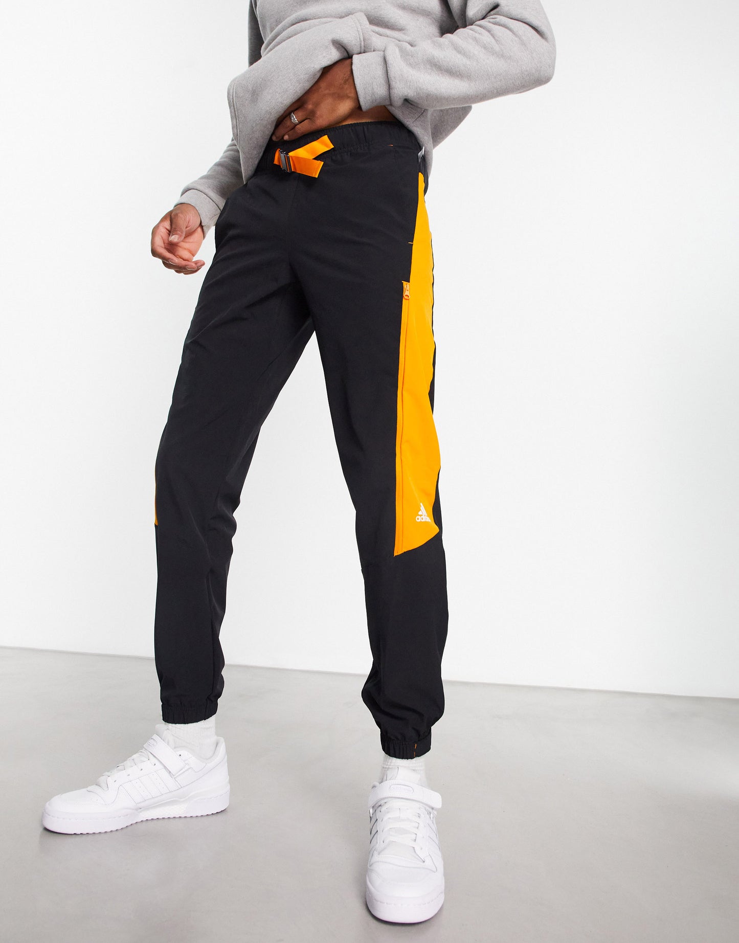 adidas Sportstyle Travel joggers in black with orange