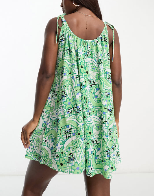 ASOS DESIGN tie strap detail trapeze mini slip dress in green tile print