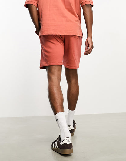 ASOS DESIGN co-ord shorts in burnt orange with celestial print