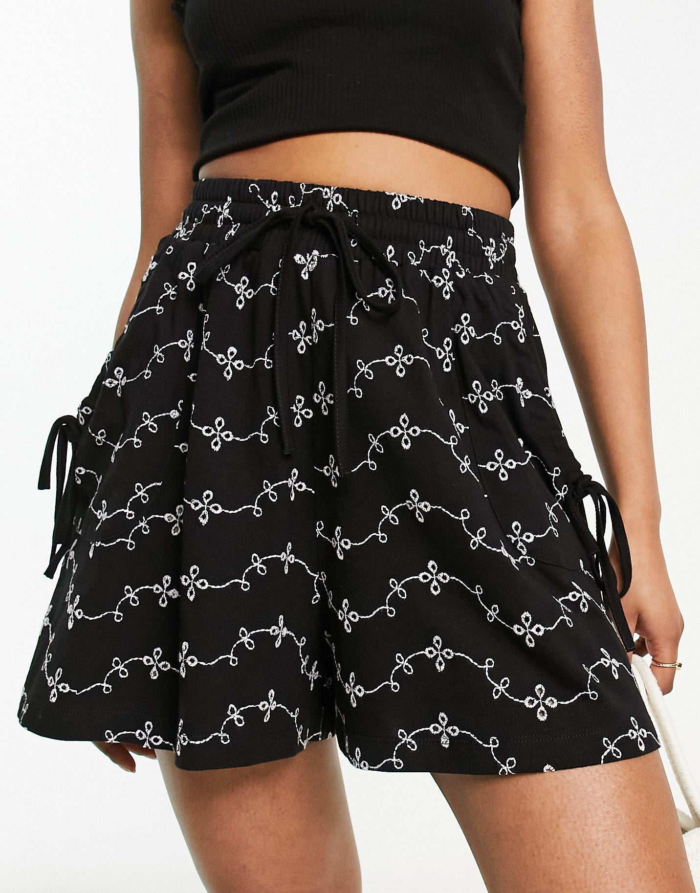 ASOS DESIGN broderie shorts with tie pockets in black/white