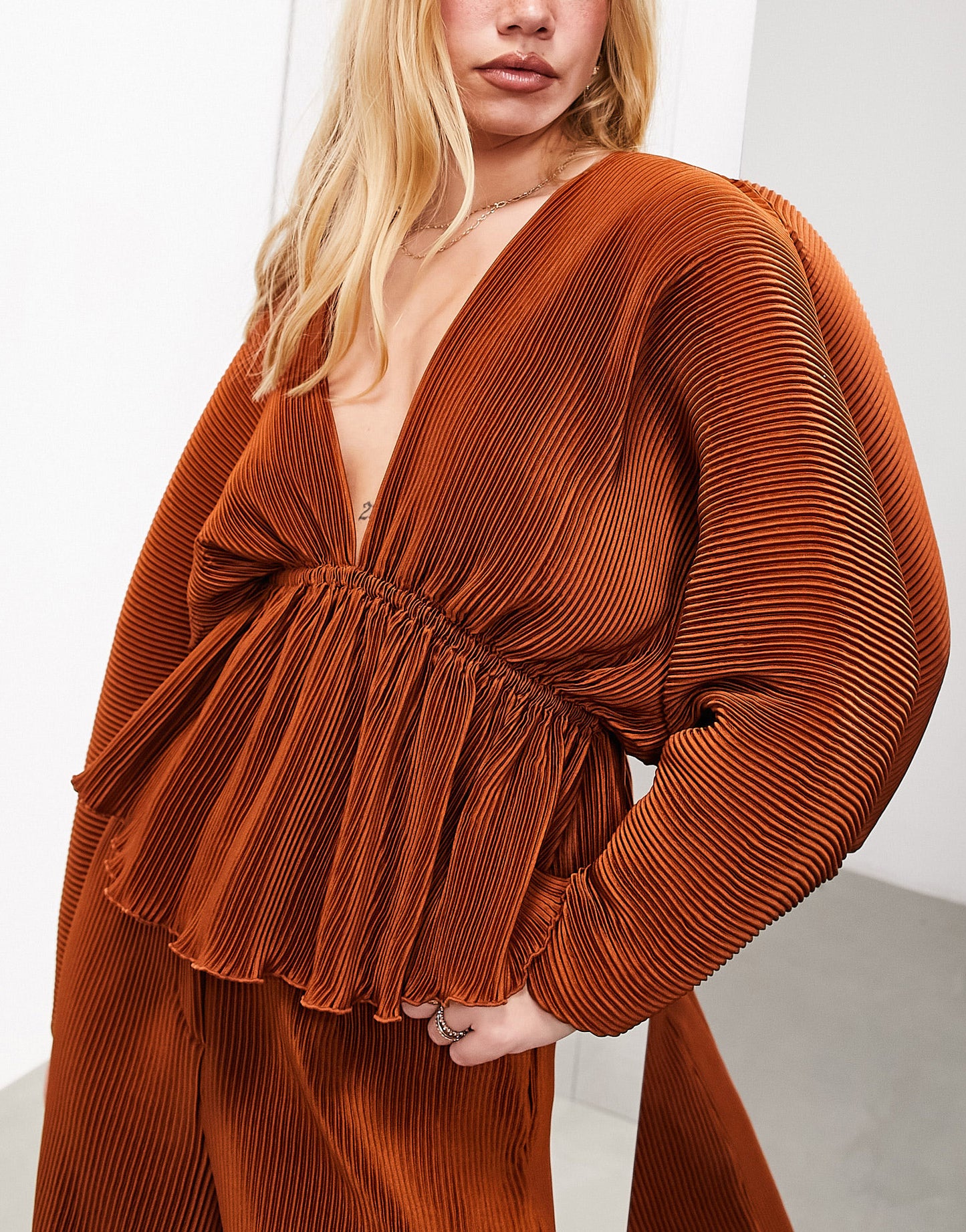 ASOS EDITION plisse volume sleeve plunge neck top in rust